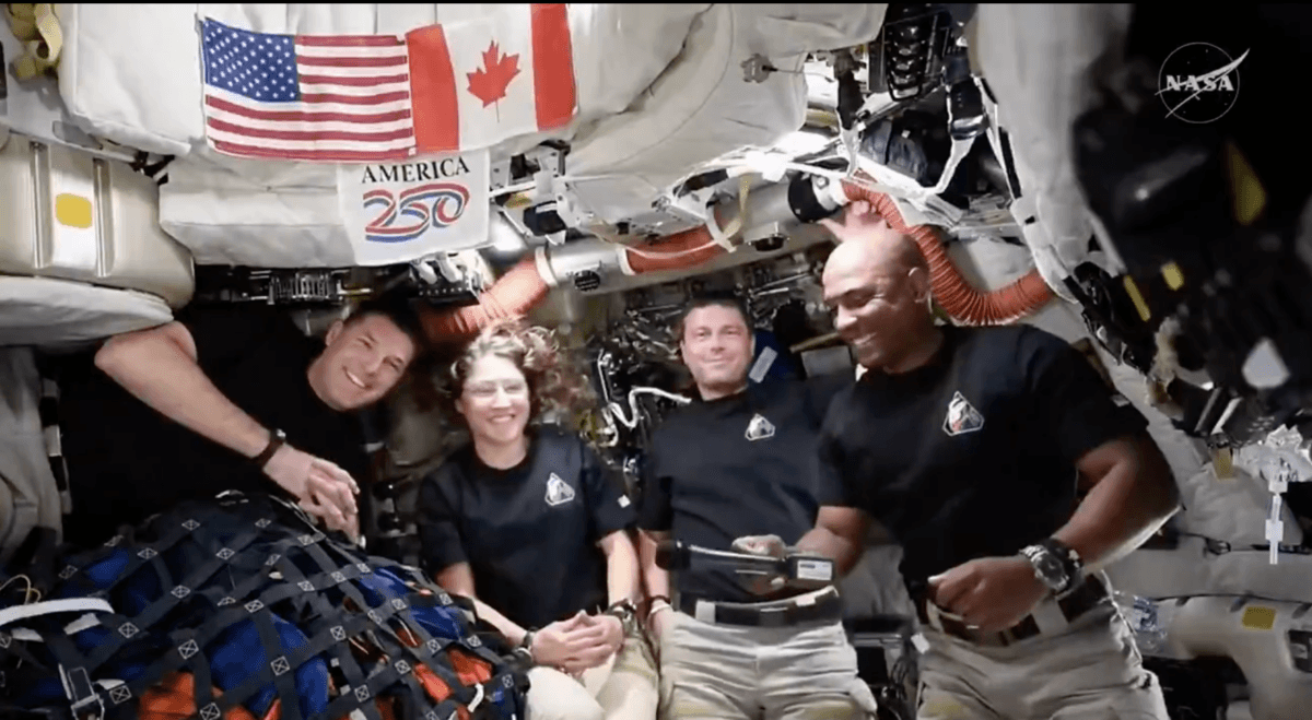 Artemis II astronauts Jeremy Hansen (L), Christina Koch (2nd L), Reid Wiseman (2nd R), and Victor Glover (R) speak with President Donald Trump while in lunar space on April 6, 2026. (Screenshot/NASA)