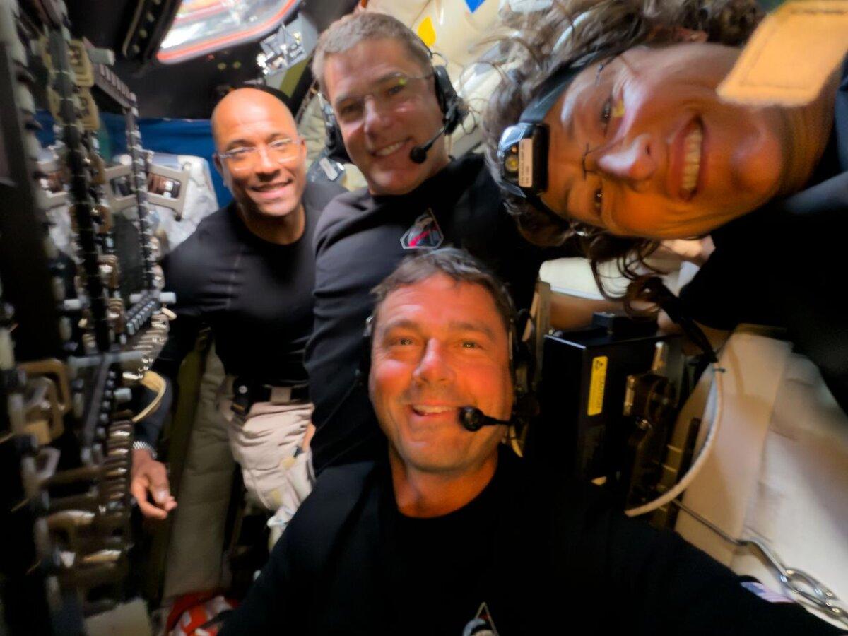 Midway through their lunar observation period, the Artemis II crew members—(L–R) Victor Glover, Jeremy Hansen, Reid Wiseman, and Christina Koch—take a selfie on April 6, 2026. (Courtesy of NASA)