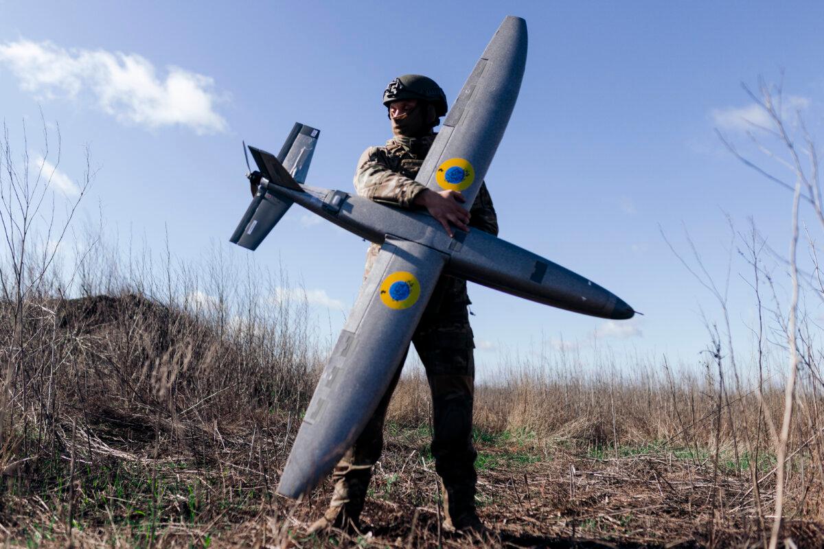 A soldier from Ukraine's Taifun unmanned aerial vehicle unit holding a new model "Marsianin" attack drone in Kharkiv region, Ukraine, on April 7, 2026. (Nikoletta Stoyanova/Getty Images)