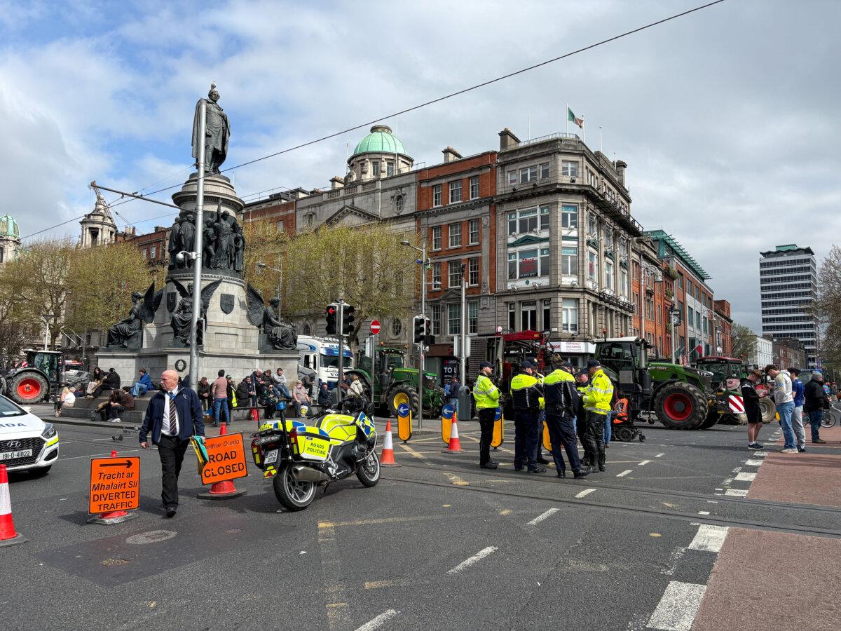 Police officers stand in the street as tractors block O'Connell Street in Dublin on April 8, 2026. (Conor Humphries/Reuters)
