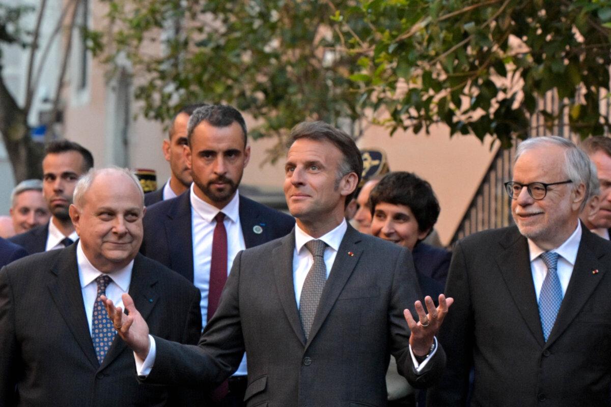 French President Emmanuel Macron (C) walks in the Trastevere neighborhood with the founder of the catholic charity Sant'Egidio community, Andrea Riccardi (R), in Rome, Italy, on April 9, 2026. (Tiziana FABI/AFP via Getty Images)