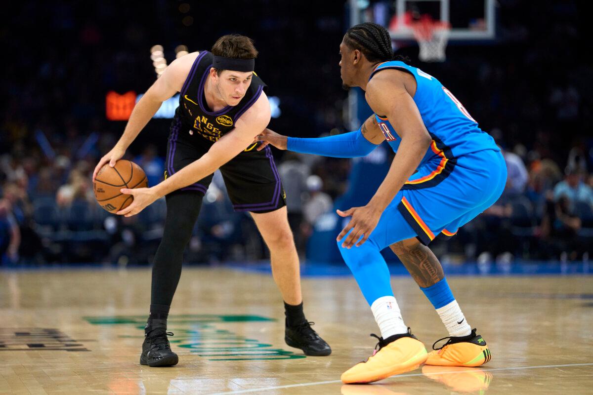 Austin Reaves (L) of the Los Angeles Lakers looks for an opening against Jalen Williams of the Thunder at the Paycom Center in Oklahoma City on April 2, 2026. (Cooper Neill/Getty Images)
