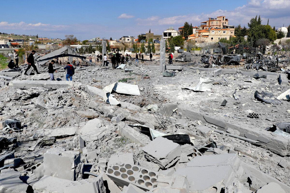 First-responders inspect destroyed vehicles and rubble and debris in the aftermath of Israeli bombardment on the village of Shmistar in the centre of Lebanon's eastern Bekaa valley on April 8, 2026. (Nidal Solh/AFP via Getty Images)