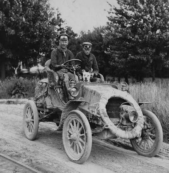 The two men and their bulldog, Bud, are prepared for a day on the road. (Public Domain)