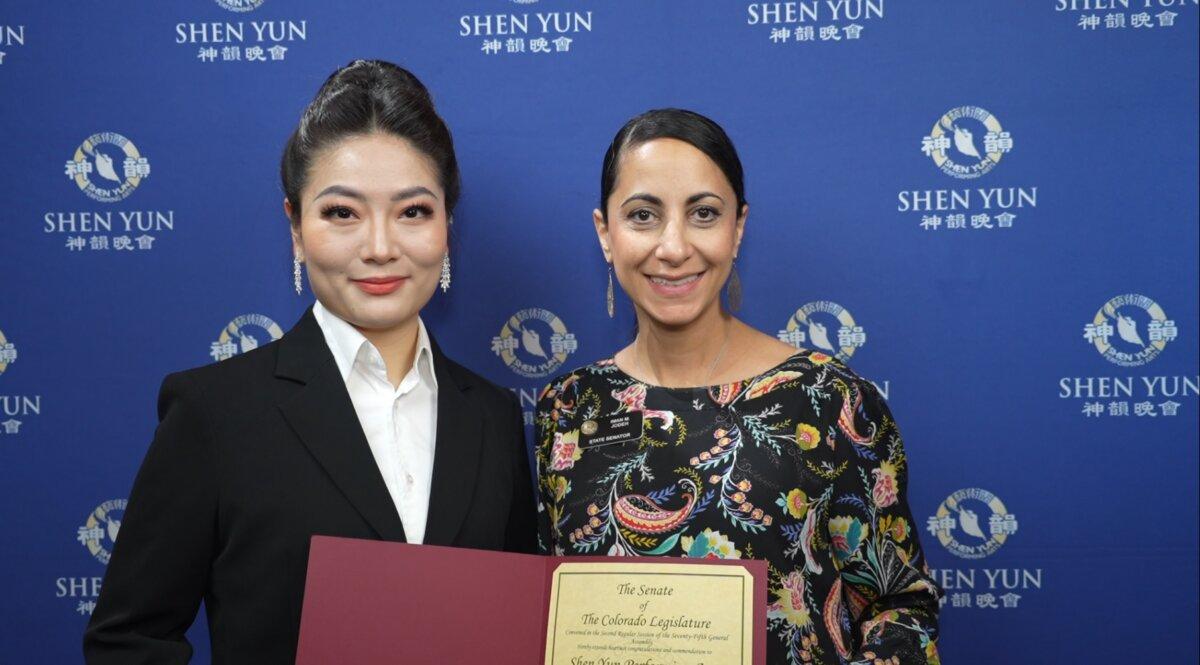 Shen Yun's soprano (L) accepts a tribute presented to Shen Yun Performing Arts by Senator Iman Jodeh (R) at <span style="font-weight: 400;">The Buell Theatre, on April 12, 2026.</span> (NTD)
