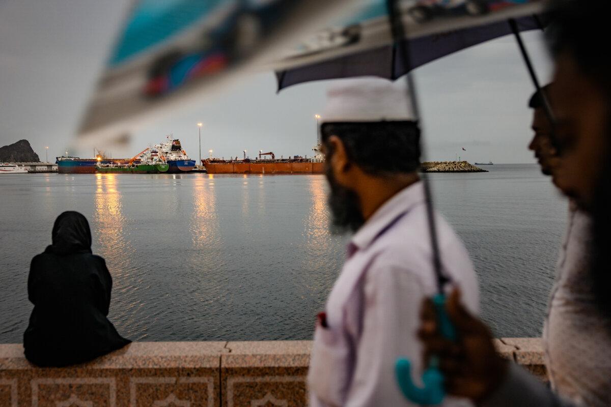 A bulk carrier sits anchored as families gather on the last day of Eid at Sultan Qaboos Port in Muscat, Oman, on March 23, 2026. (Elke Scholiers/Getty Images)