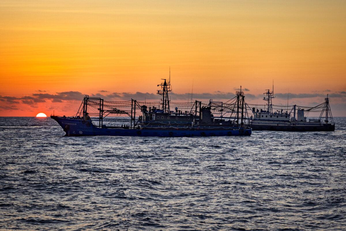 Chinese militia ships are seen as Philippine ships conduct a resupply mission to troops stationed at Second Thomas Shoal in the South China Sea on March 5, 2024. (Ezra Acayan/Getty Images)