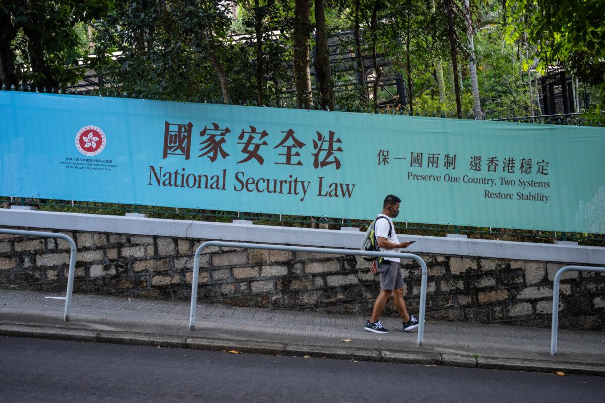 Pedestrians walk past a government-sponsored advertisement promoting a new national security law in Hong Kong on June 30, 2020. (Billy H.C. Kwok/Getty Images)