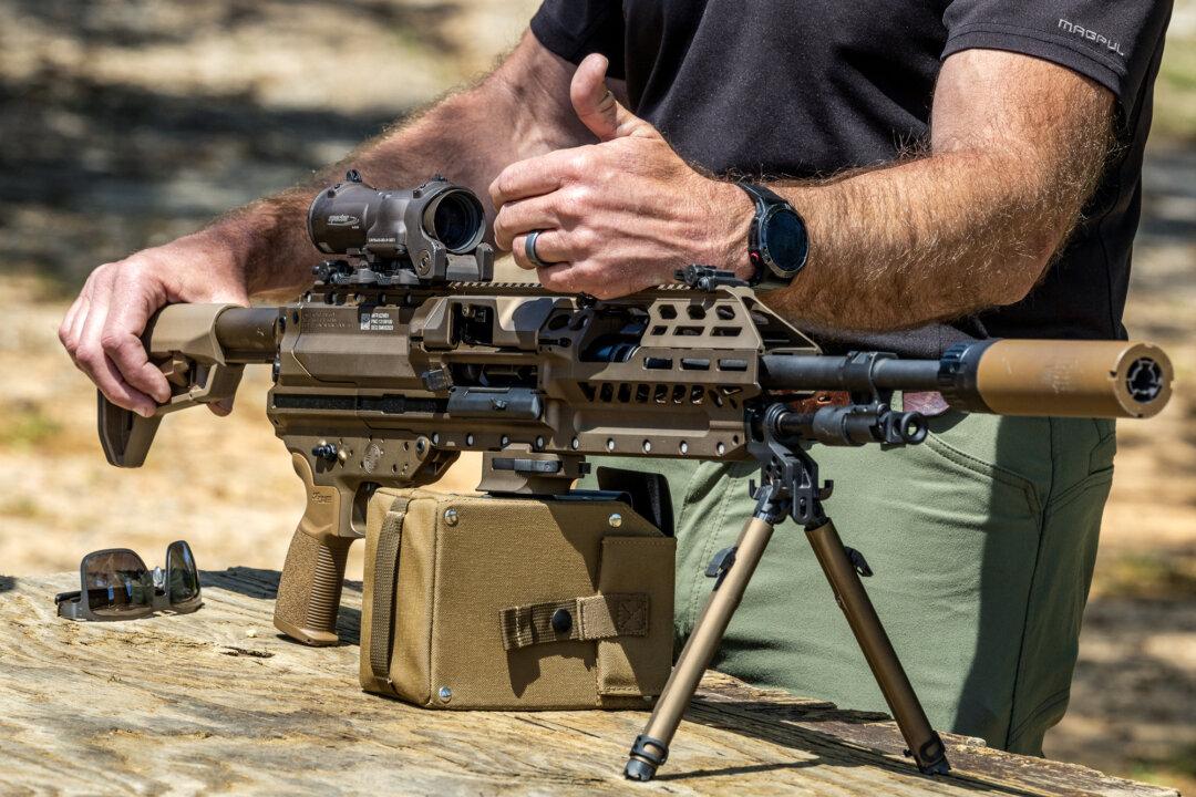 Daryl Easlick, a test and evaluation manager for the Army’s Maneuver Future Capability Directorate, displays the M250 light machine gun at a shooting range in Fort Benning, Ga., on April 8, 2026. (John Fredricks/The Epoch Times)