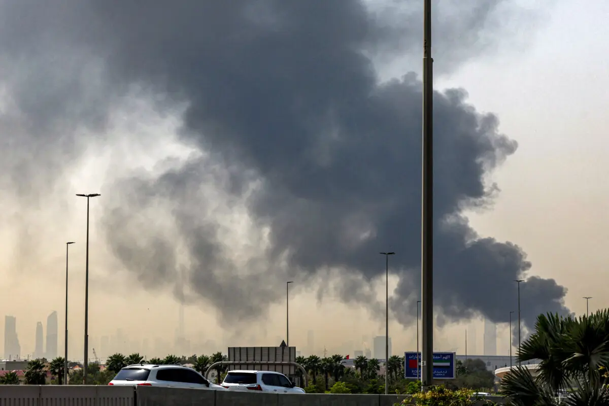 Iran Signals It May Skip Next US-Led Peace Talks as Israel Warns of Renewed Fighting | USNN World News The Dubai skyline with the landmark Burj Khalifa skyscraper is pictured as a smoke plume rises from an ongoing fire near Dubai International Airport, the United Arab Emirates, on March 16, 2026. (Photo by AFP via Getty Images)