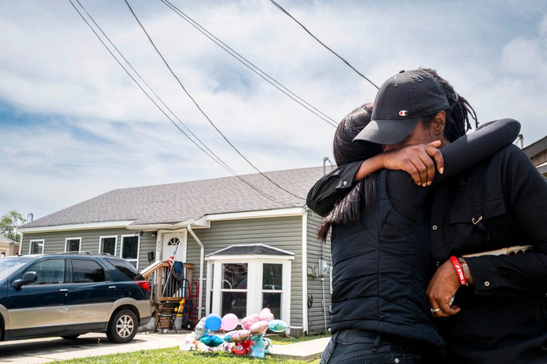 SHREVEPORT, LOUISIANA - APRIL 20: People grieve in front of the home where Sunday's shooting spree occurred on April 20, 2026 in Shreveport, Louisiana. Eight children were killed and two women were wounded during a domestic violence incident in the early morning hours on April 19, according to local authorities. (Photo by Brandon Bell/Getty Images)
