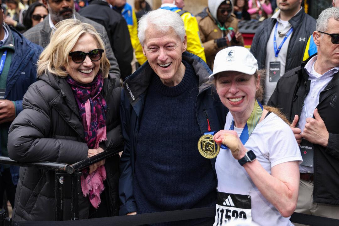 BOSTON, MASSACHUSETTS - APRIL 20: Former U.S. President Bill Clinton, former Secretary of State Hillary Clinton, and Chelsea Clinton pose after Chelsea finished the 130th Boston Marathon on April 20, 2026 in Boston, Massachusetts. (Photo by Paul Rutherford/Getty Images)