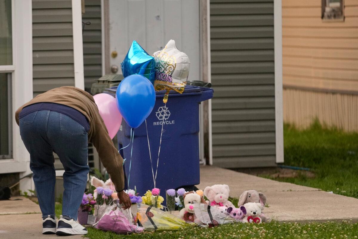 A person leaves a gift at a makeshift memorial on the front lawn of the home where children were killed during a mass shooting the day before in Shreveport, La., on April 20, 2026. (Gerald Herbert/AP Photo)