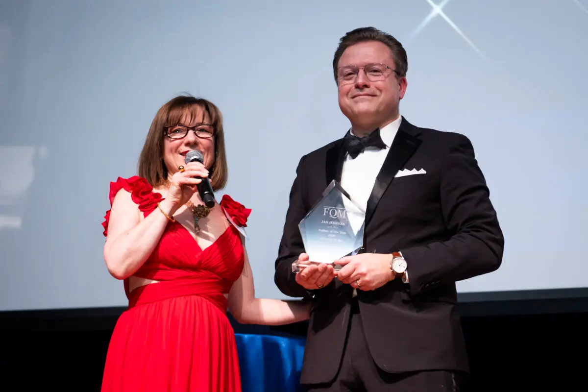 Isabelle Karamooz, founder, CEO, and publisher of French Quarter Magazine, presents the magazine's 2026 Best Author of the Year award to Jan Jekielek, Epoch Times senior editor and author of "Killed to Order," at the French Embassy in Washington on April 20, 2026. (Madalina Kilroy/The Epoch Times)