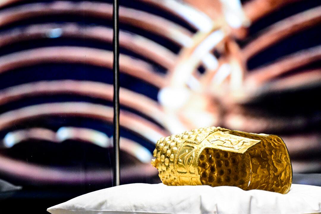 The ancient Cotofenesti helmet and two Dacian gold bracelets are on display at the National Museum of History of Romania (MNIR) in Bucharest on April 21, 2026. The artifacts, shown together for the first time since their repatriation, are part of a national campaign to bring Romania's most significant ancient treasures to the public across the country. In January 2025, the Cotofenesti helmet and several gold bracelets were stolen from the Drents Museum in Assen, Netherlands. They were on loan from the National Museum of History of Romania (MNIR) as part of the "Dacia Empire of Gold and Silver" exhibition. (Photo by Daniel MIHAILESCU / AFP via Getty Images)