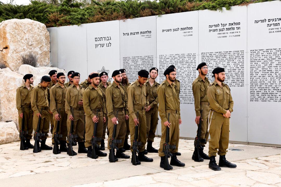 TOPSHOT - Israeli soliders observe a two minute silence at the Armoured Corps Memorial, following a ceremony to mark Remembrance Day, commemorating fallen Israeli soldiers in Latrun, between Jerusalem and Tel Aviv on April 21, 2026. At sunset on April 20, gatherings at military cemeteries and war memorials took place to commemorate Remembrance Day which gives way to public performances, street parties and general merrymaking to mark 78 years since the declaration of the Israeli state in 1948. (Photo by Jack GUEZ / AFP via Getty Images)