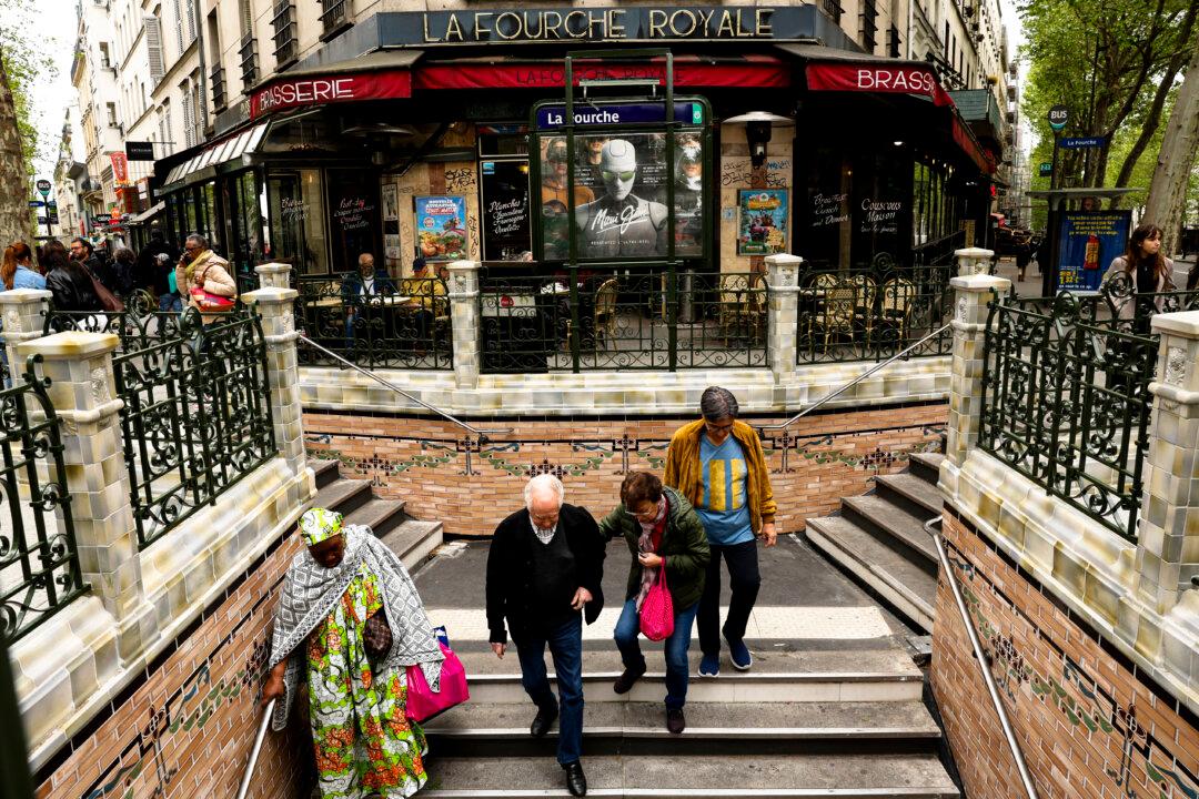 Commuters enter the newly renovated public transport metro station La Fourche in Paris on April 21, 2026. The station was renovated to match its original design. It had been damaged in a bus accident in 1964. (Photo by Charlotte SIEMON / AFP via Getty Images)