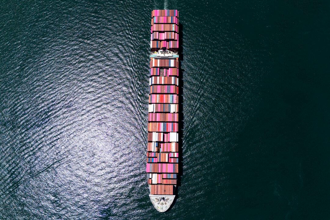 TOPSHOT - Aerial view of the One Contribution container ship sailing under the Tokio flag as it enters the Panama Canal in Panama City on April 21, 2026. According to the Panama Canal Authority, transit through the canal has increased due to the war in the Middle East. (Photo by MARTIN BERNETTI / AFP via Getty Images)