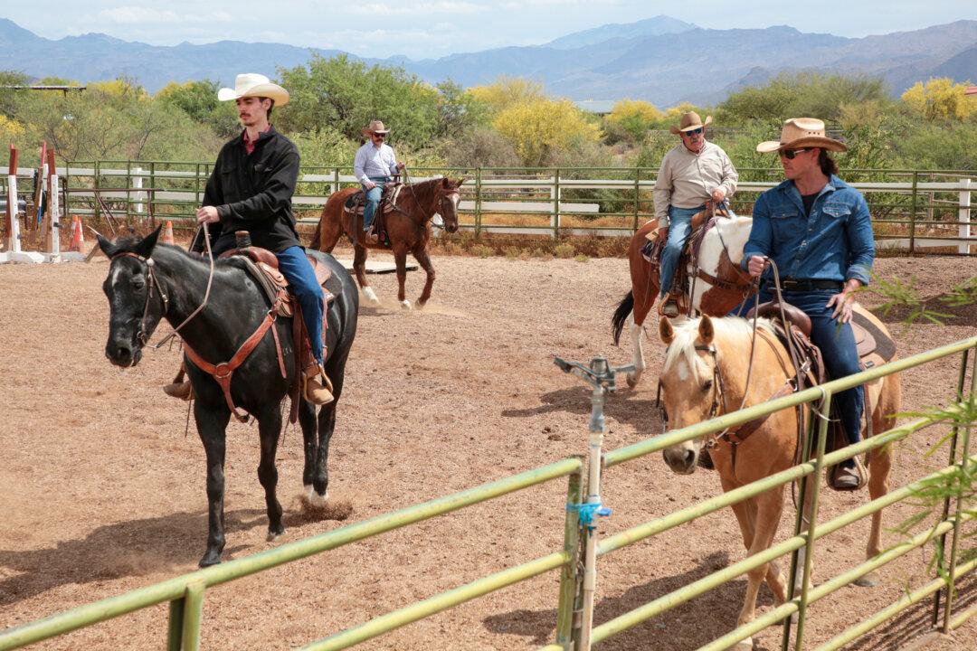 Arizona Cowboy College attendees Carmine, Alec, and Jason ride horses at the college's facility in Scottsdale, Ariz., on April 13, 2026. (Richard Moore/The Epoch Times)