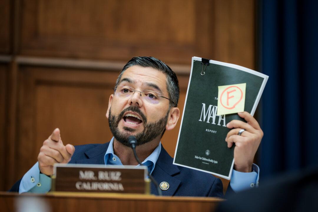 Rep. Raul Ruiz (D-Calif.) holds up the Make Our Children Healthy Again Assessment report while questioning Health and Human Services Secretary Robert F. Kennedy Jr. during a House Energy and Commerce Committee Health Subcommittee hearing in Washington on June 24, 2025. (Kayla Bartkowski/Getty Images)