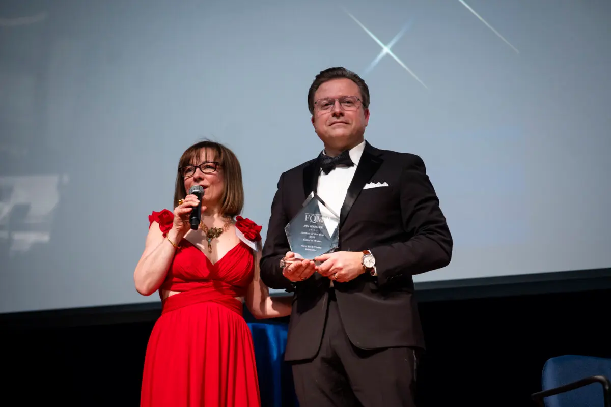 Isabelle Karamooz, founder, CEO, and publisher of French Quarter Magazine, presents the magazine's 2026 Best Author of the Year award to Jan Jekielek, Epoch Times senior editor and author of "Killed to Order," at the French Embassy in Washington on April 20, 2026. (Madalina Kilroy/The Epoch Times)
