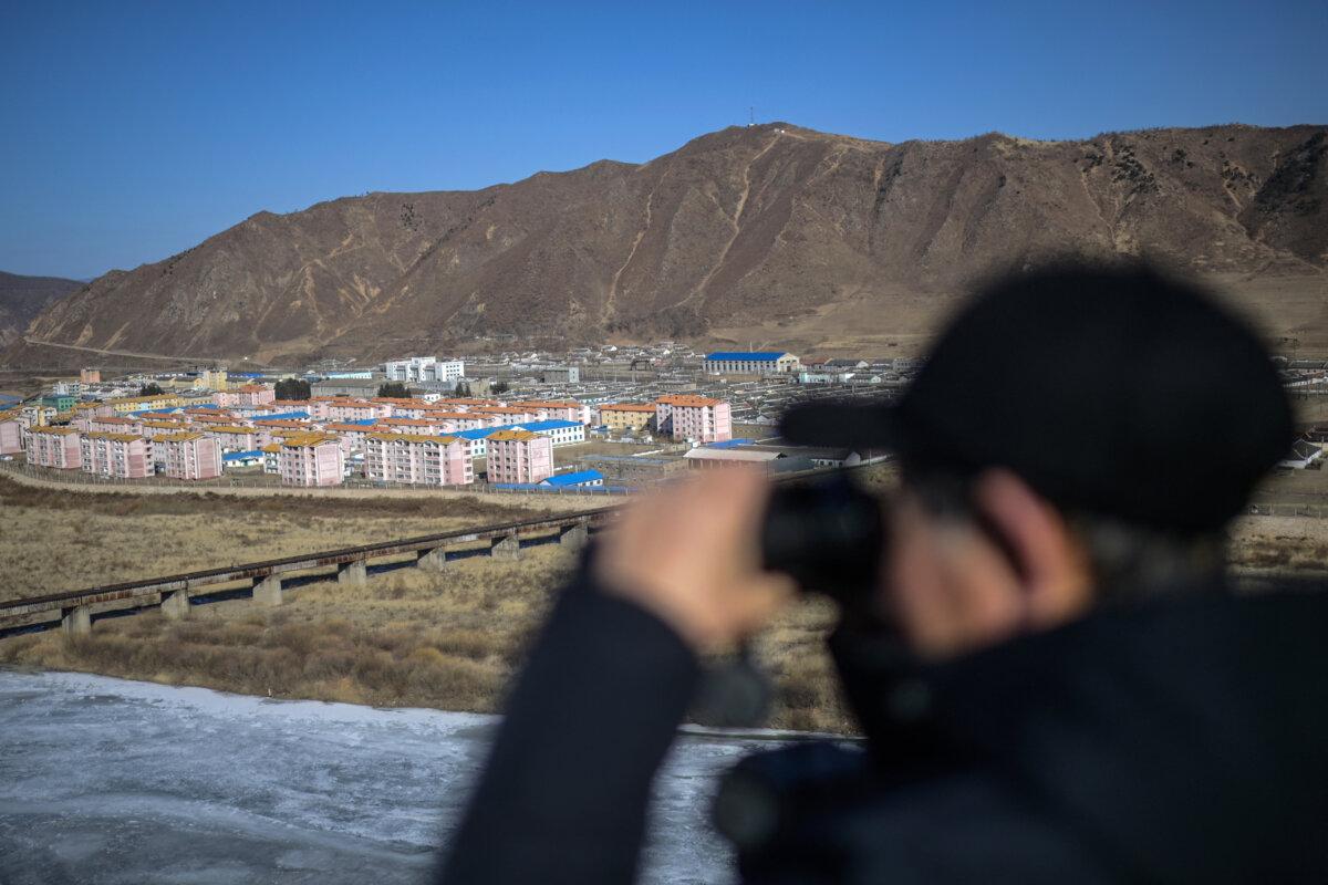A man looks toward the North Korean city of Namyang from the city of Tumen in northeast China's Jilin Province on Feb. 26, 2024. (Pedro Pardo/AFP)