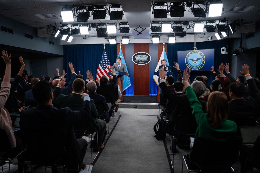 Secretary of War Pete Hegseth and Gen. Dan Caine, chairman of the Joint Chiefs of Staff, speak during a press briefing at the Pentagon in Arlington, Va., on April 24, 2026. (Madalina Kilroy/The Epoch Times)