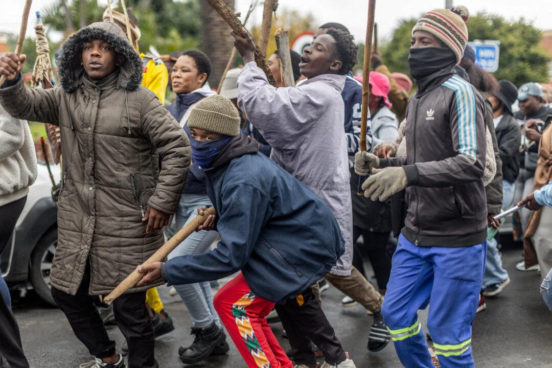 TOPSHOT - Protesters sing and chant during a protest march against undocumented migrants in the town of Estcourt on April 24, 2026. South Africa's acting police minister has condemned xenophobic incidents, saying attacks on foreign nationals were "unlawful" and violated the country's constitutional values of dignity and equality. (Photo by RAJESH JANTILAL / AFP via Getty Images)