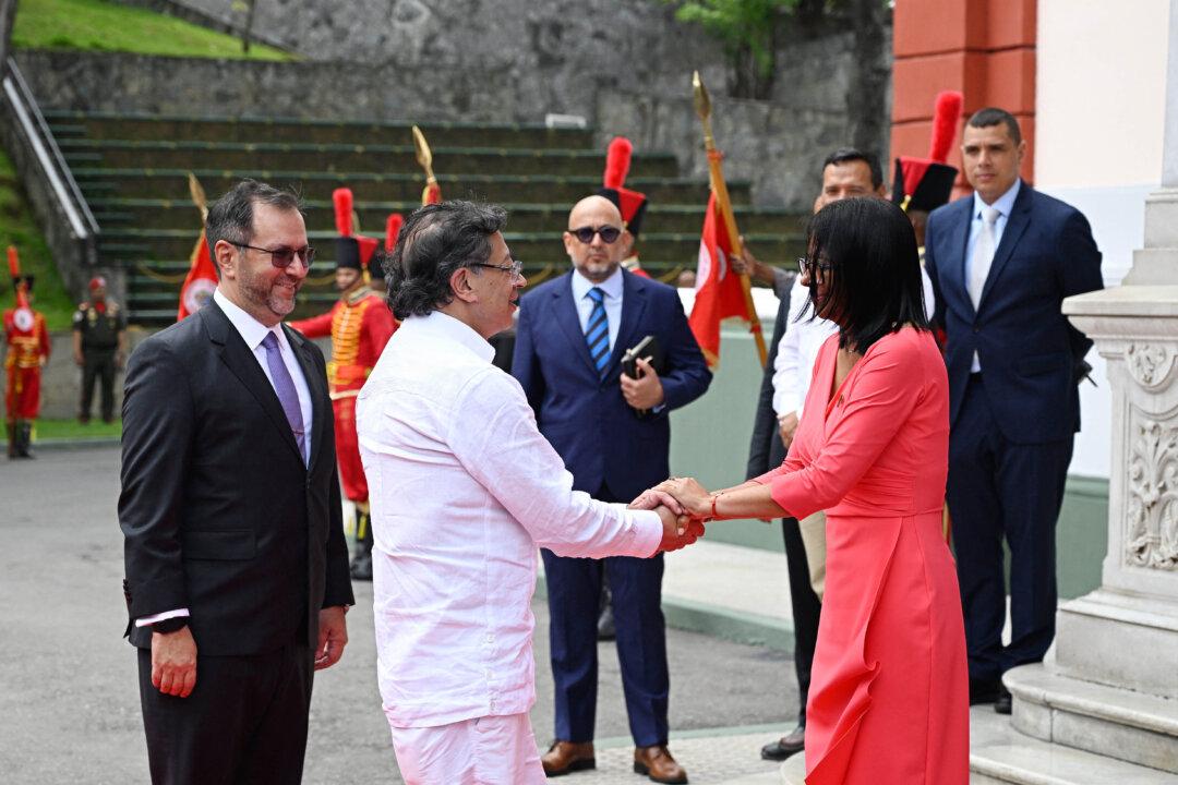 Colombia's President Gustavo Petro and Venezuela's interim President, Delcy Rodriguez, shake hands next to Venezuela's Foreign Minister Yvan Gil (L) upon his arrival to a bilateral meeting at the Miraflores Presidential Palace in Caracas on April 24, 2026. Colombia's President Gustavo Petro arrived in Venezuela on April 24 for a bilateral meeting with interim President Delcy Rodriguez, focusing on border security and energy cooperation. (Photo by Federico PARRA / AFP via Getty Images)