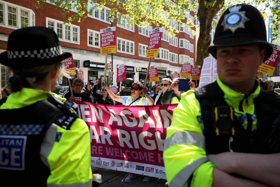 LONDON, ENGLAND - APRIL 24: Members of the "Women Against The Far-Right" protest outside the British Home Office on April 24, 2026 in London, England. The "Pink Ladies" anti-immigration group were met by a "Women Against The Far-Right" counterprotest, the day after the UK and France agreed to a new three-year deal over the policing of migrants traveling to England in small boats via the English Channel. (Photo by Dan Kitwood/Getty Images)