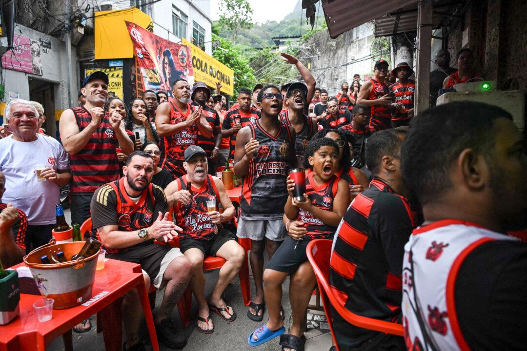 Flamengo supporters react as they watch the final match of the 2025 FIFA Intercontinental Cup between Paris Saint-Germain and Flamengo at Rocinha favela in Rio de Janeiro on Dec. 17, 2025. (Primentel/AFP via Getty Images)