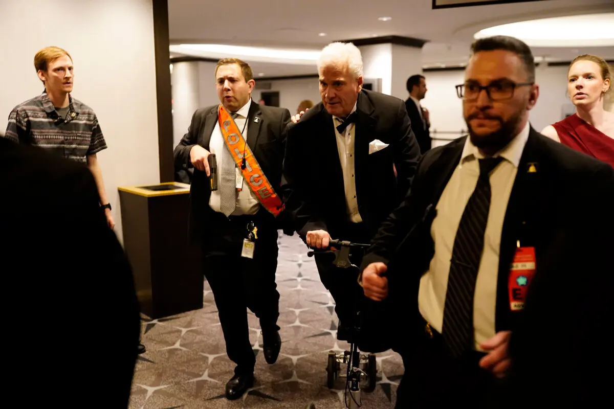 Agents escort people out after an incident at the annual White House Correspondents Association Dinner in Washington on April 25, 2026. (Nathan Howard/Getty Images)
