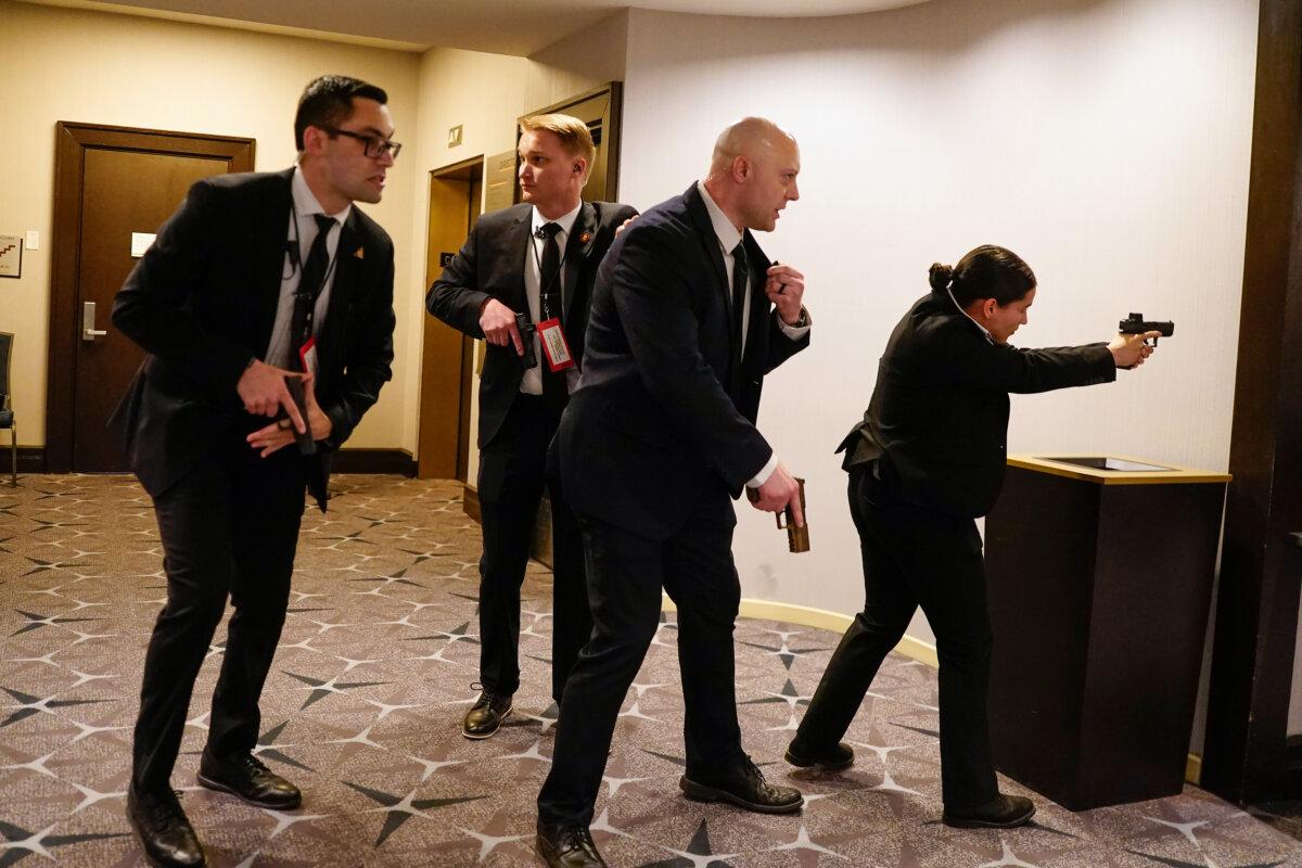 Federal agents react after shots were fired at the hotel where the annual White House Correspondents Association Dinner was held in Washington on April 25, 2026. (Nathan Howard/Getty Images)