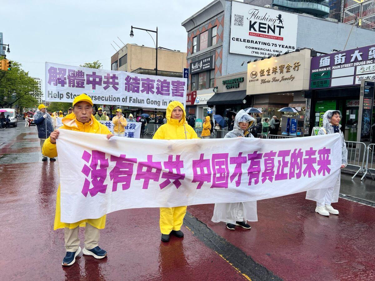 Charlie Yu (far L) holds up a banner during a parade commemorating the 27th anniversary of the April 25 appeal, in Flushing, New York, on April 25, 2026. (Sarah Lu/The Epoch Times)