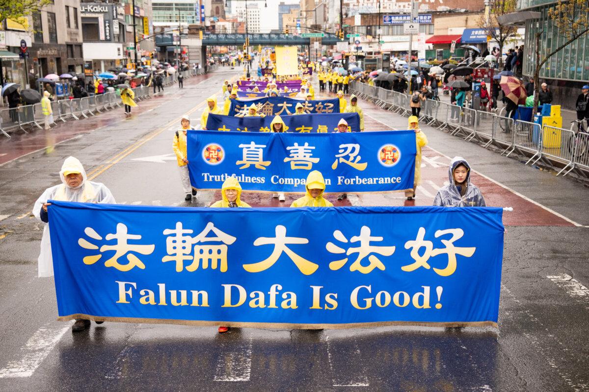 Falun Gong practitioners hold up banners during a parade commemorating the 27th anniversary of the April 25 appeal, in Flushing, New York, on April 25, 2026. (Larry Dye/The Epoch Times)