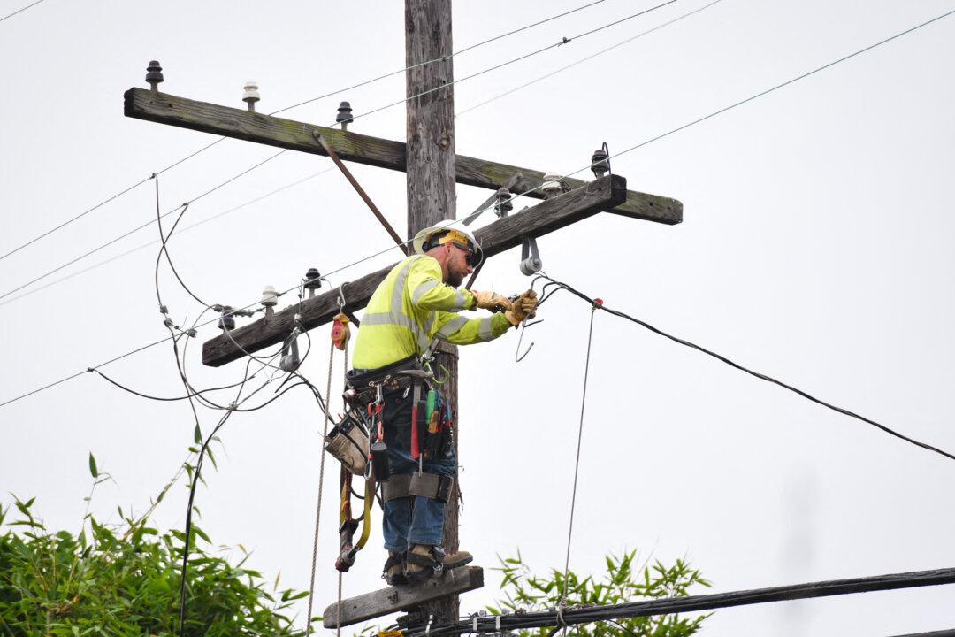 An Edison Electricity Company technician works on restoring power to a utility pole after replacing a transformer in Culver City, Calif., on July 13, 2025. Recent estimates suggest the United States will need $1.4 trillion by 2030 and more than $3 trillion by 2035 to modernize and expand its electrical infrastructure. (Chris Delmas/AFP via Getty Images)