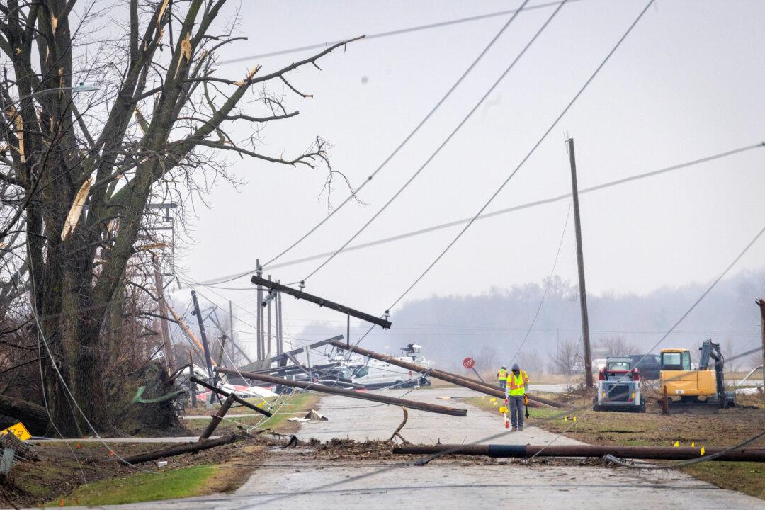 Power lines are draped across the road after a tornado passed through the small town of Lake Village, Ind., on March 11, 2026. During events such as extreme weather or fires, even a single transformer malfunction can cut power to thousands of people. (Scott Olson/Getty Images)