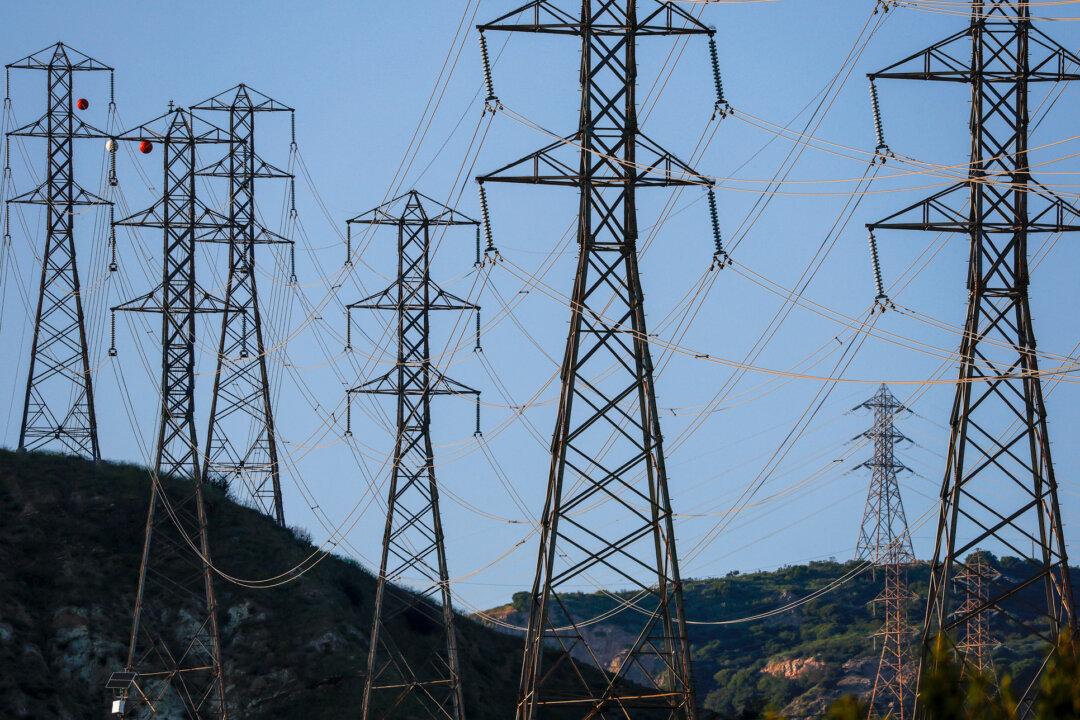 Electrical transmission towers in Sylmar, Calif., on March 24, 2026. The United States is building only a fraction of the high-voltage capacity needed to meet rising electricity demand from artificial intelligence, data centers, and growing population centers. (Justin Sullivan/Getty Images)