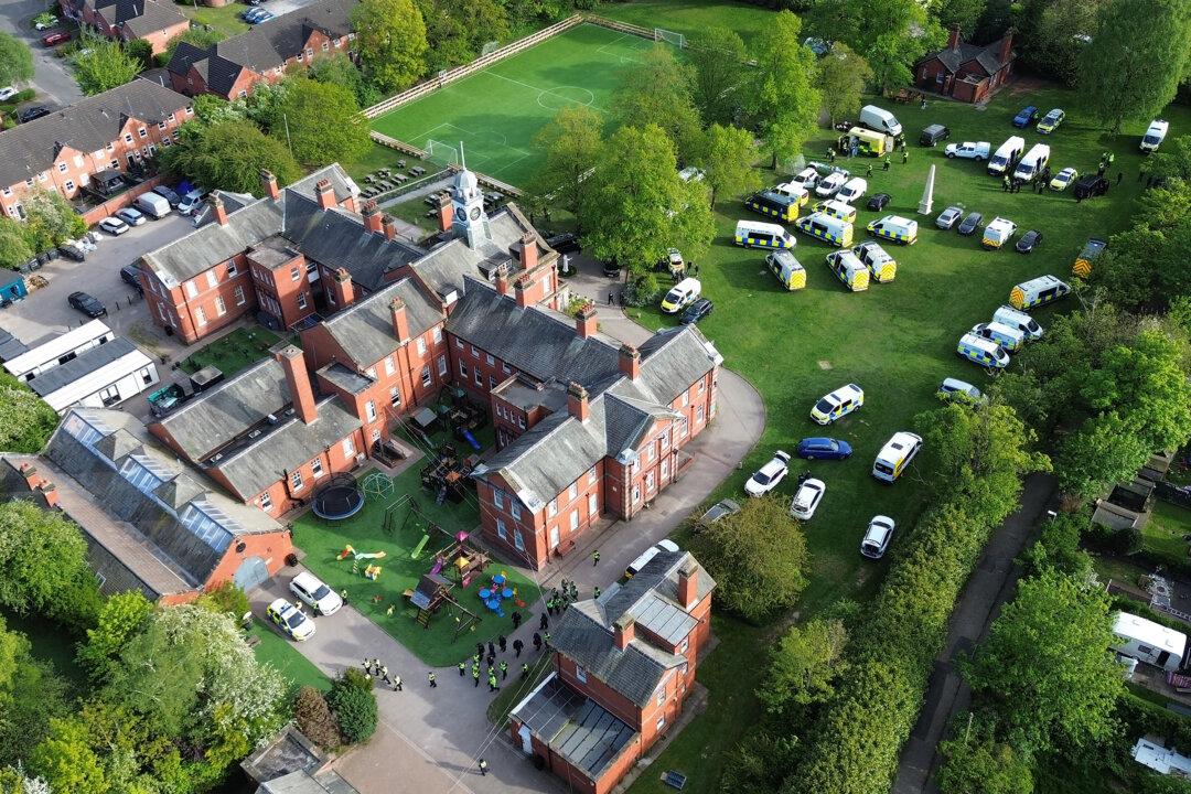 An aerial view of police in attendance at the Webb House compound for the Ahmadi Religion of Peace and Light (AROPL) in Crewe, England, on April 29, 2026. (Ryan Jenkinson/Getty Images)