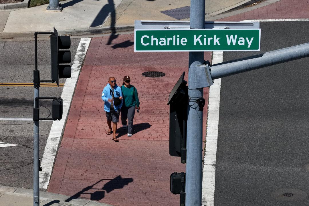 Pedestrians walk by a newly installed Charlie Kirk Way sign in Westminster, Calif., on April 29, 2026. The city of Westminster became the first city in the nation to dedicate a street to the late conservative activist and podcaster Charlie Kirk, who was fatally shot in 2025, with the designation installed near Westminster Boulevard and All American Way. (Justin Sullivan/Getty Images)
