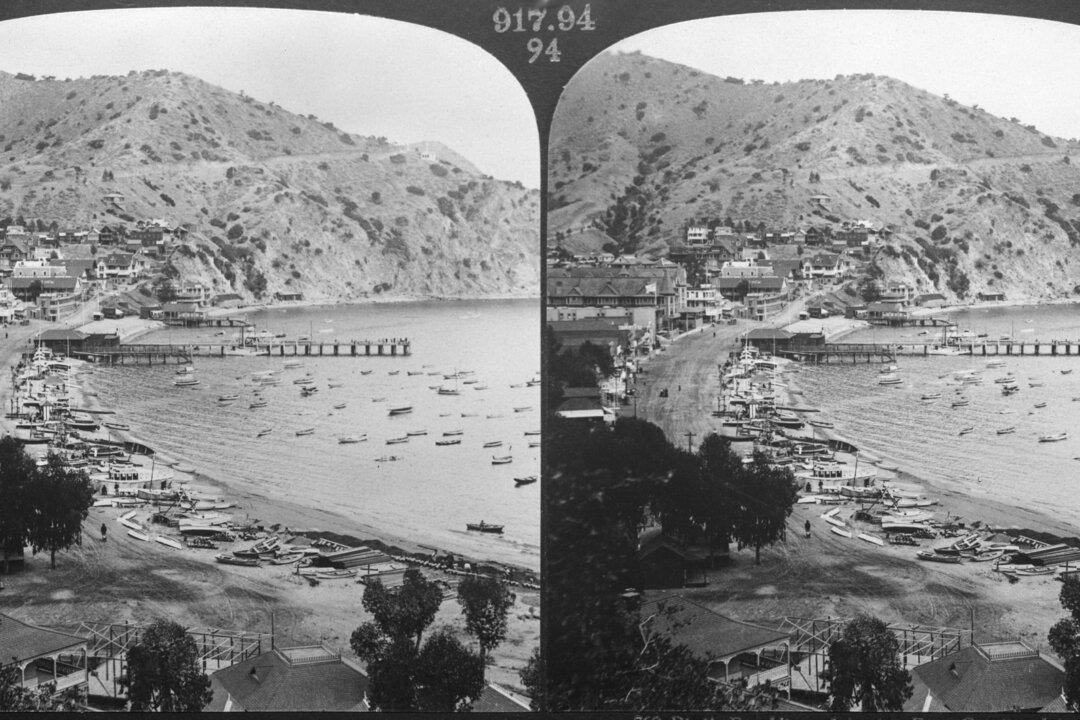 A stereoscopic image shows a high-angle view of Avalon Bay, with boats pulled ashore and a pier extending into the water near Catalina Island, Calif., in 1906. (H.C. White Co./Graphic House/Hulton Archive/Getty Images)