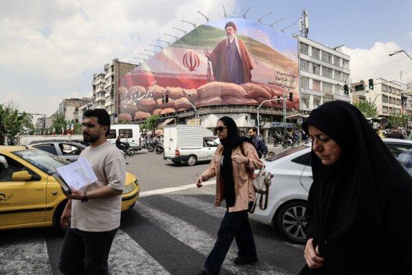 US Treasury Warns Ships Not to Pay Strait of Hormuz Tolls to Iran | USNN World News Iranians walk past a large billboard depicting Iranian leader Ayatollah Mojtaba Khamenei on a street in Tehran on April 20, 2026. (Atta Kenare/AFP via Getty Images)