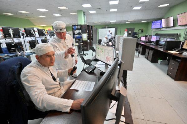 Employees of the control panel of the New Safe Confinement (NSC), covering the destroyed fourth reactor at the Chernobyl Nuclear Power Plant, work on April 23, 2026. (Sergei SUPINSKY / AFP via Getty Images)