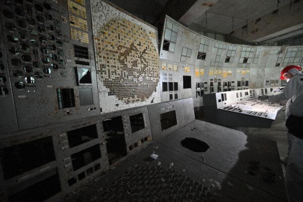 A visitor of the Chernobyl Nuclear Power Plant films in the control room of the destroyed 4th block of the plant on April 23, 2026. (Sergei SUPINSKY / AFP via Getty Images)