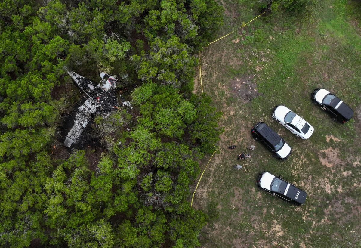 A crashed Cessna airplane in a wooded area on Round Rock Road in Wimberley, Texas, on May 1, 2026. (Jay Janner/Austin American-Statesman via AP)