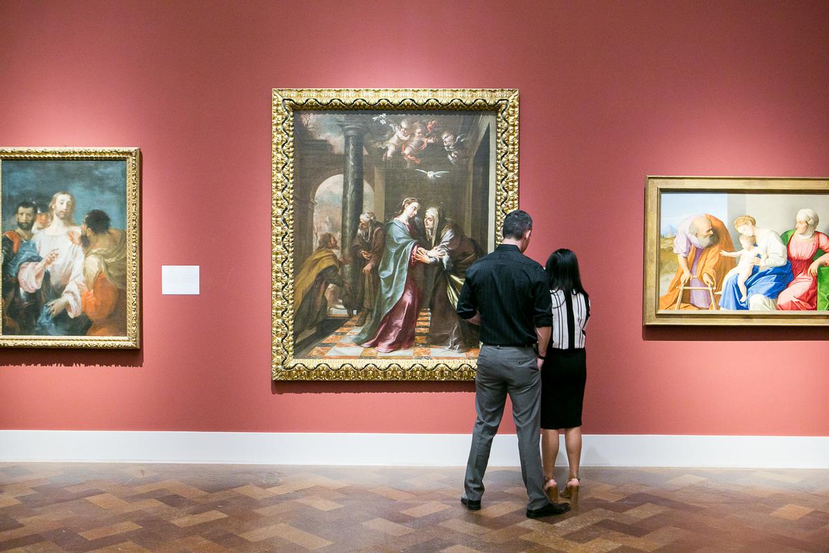 Visitors admire the 1673 Spanish painting “The Visitation” by Juan de Valdés Leal, which the museum acquired in 2014. (Courtesy of The San Diego Museum of Art)