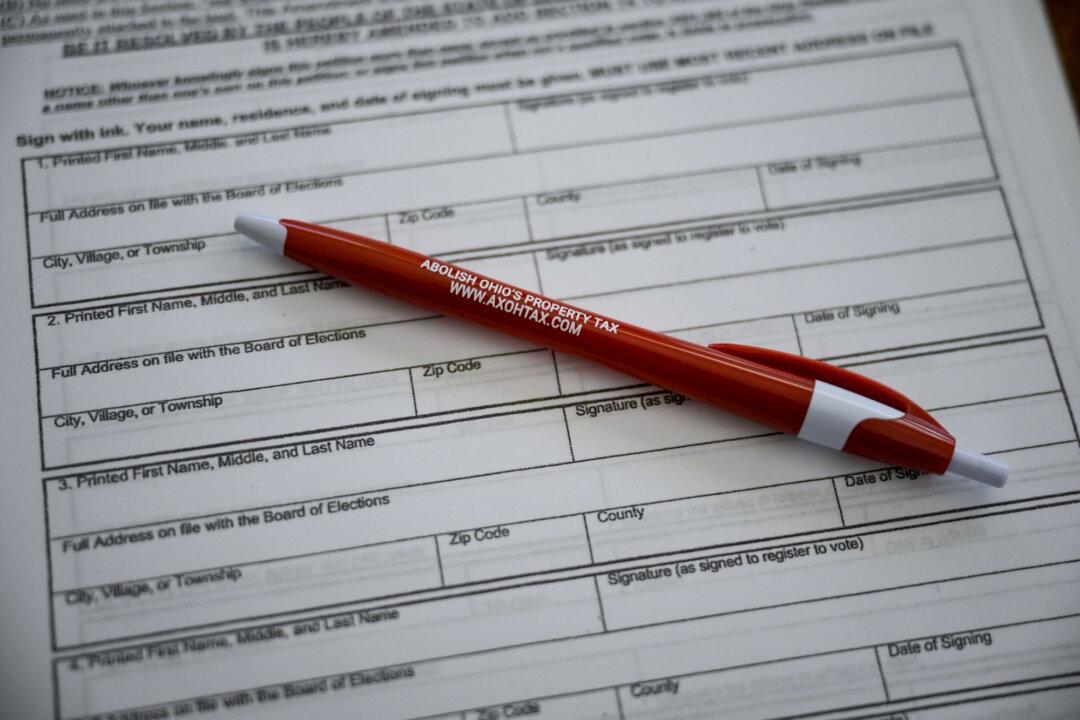 A pen and petition at Ron Shumate’s home in Springfield Township, Ohio, on April 21, 2026. Shumate said the state should find alternative revenue sources to fund schools and local government. (Glenn Hartong for The Epoch Times)
