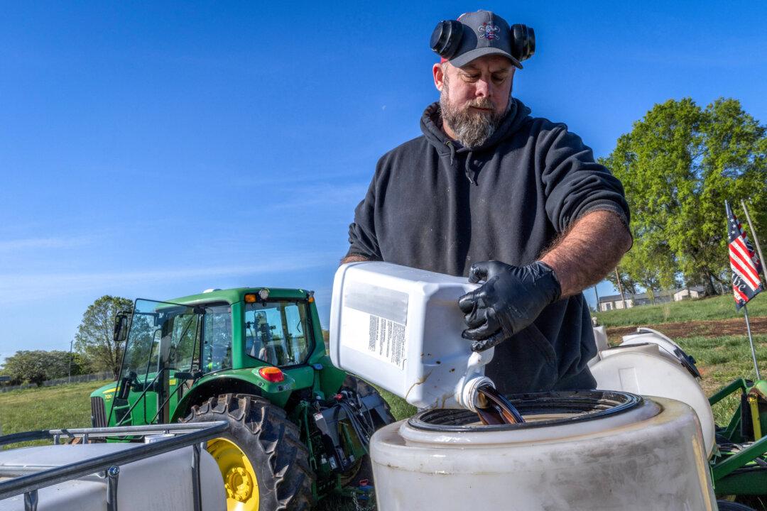 A farmer prepares a blend of minerals, biologicals, and fertilizers to be sprayed onto fields during seeding in Hickory, N.C., on April 10, 2026. Experts say demand for fuels such as diesel and jet fuel is one reason U.S. refineries favor heavier crude. (Grant Baldwin/AFP via Getty Images)