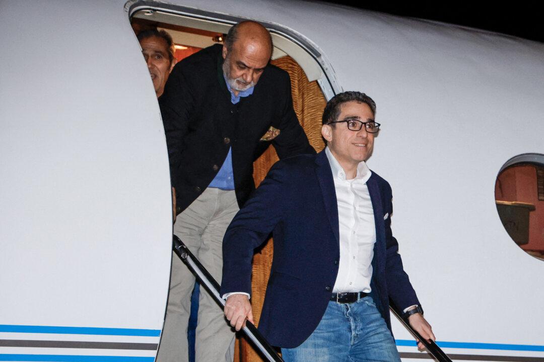 Freed U.S. citizens Siamak Namazi (R), Morad Tahbaz, and Emad Shargi disembark from an airplane at Davison Army Airfield at Fort Belvoir, Va., on Sept. 19, 2023. (Jonathan Ernst/POOL/AFP via Getty Images)