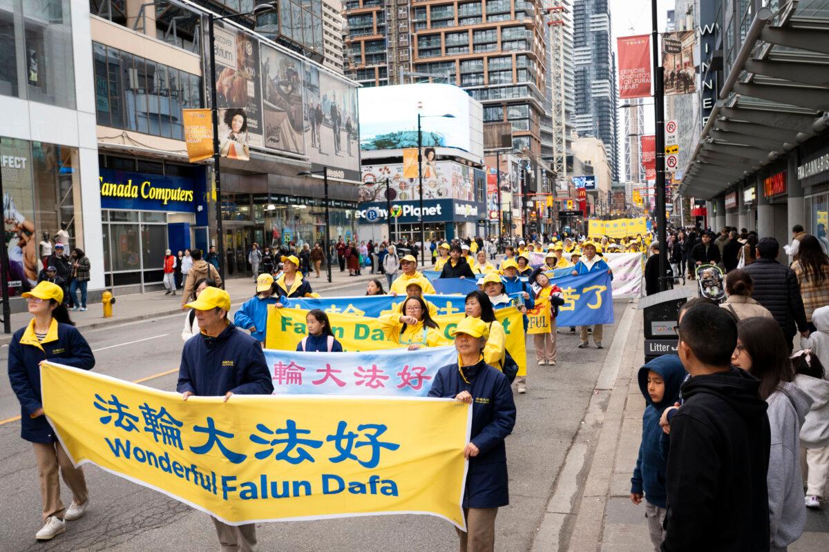 Falun Dafa practitioners participate in a parade in downtown Toronto on May 3, 2026, marking the 34th World Falun Dafa Day. (Evan Ning/The Epoch Times)